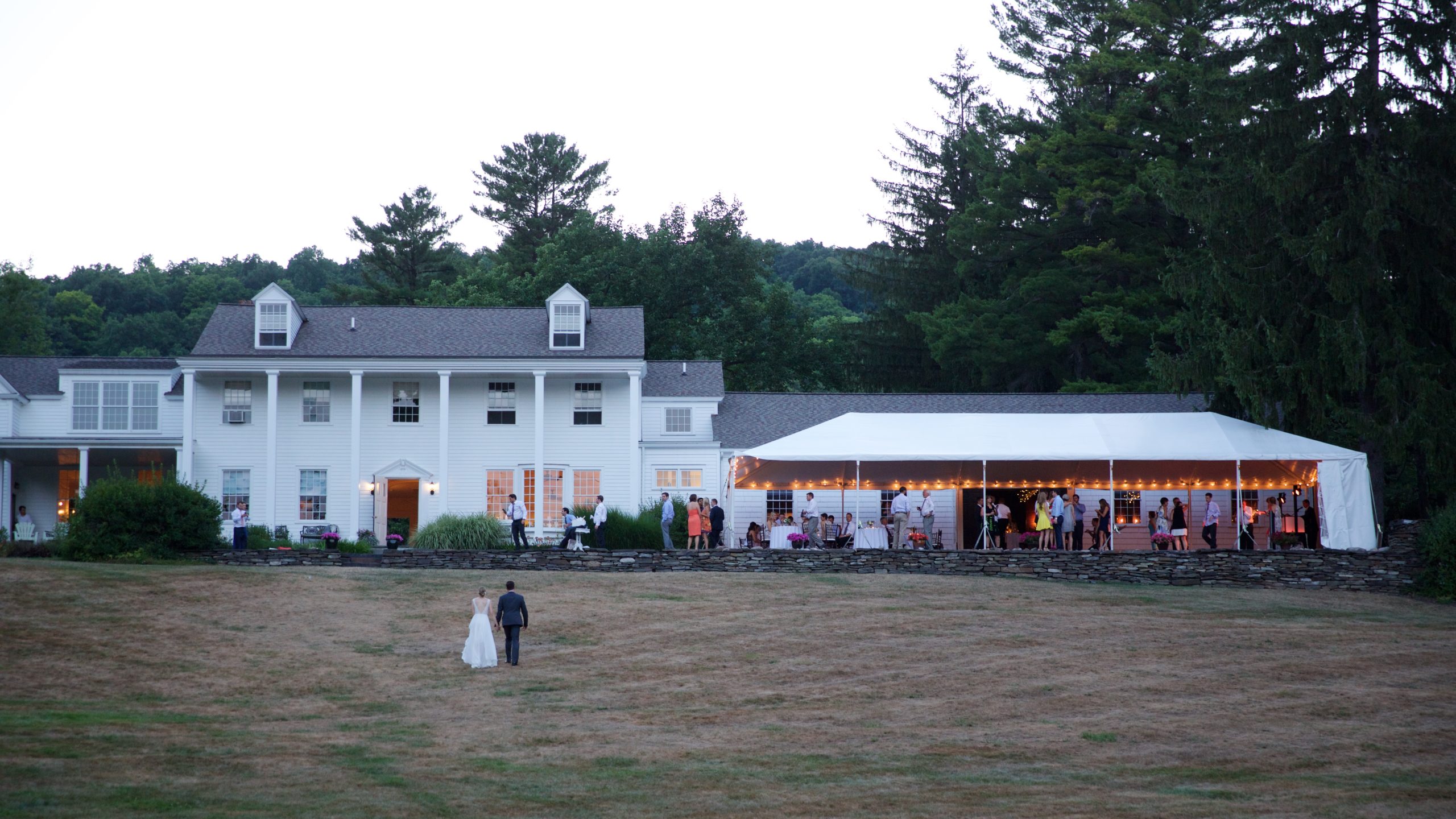 Wedding Couple walking up the hill to their wedding reception at Fountainebleau Inn