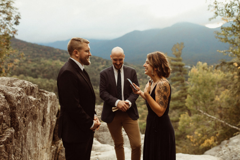 A couple is reading their vows during their elopement ceremony in the Adirondacks.