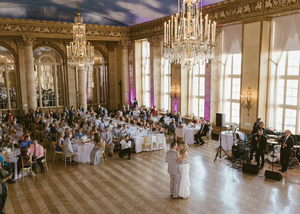 A bride and groom share their first dance in the Grand Ballroom at one of the best wedding venues in Syracuse, Marriott Downtown Hotel Syracuse.