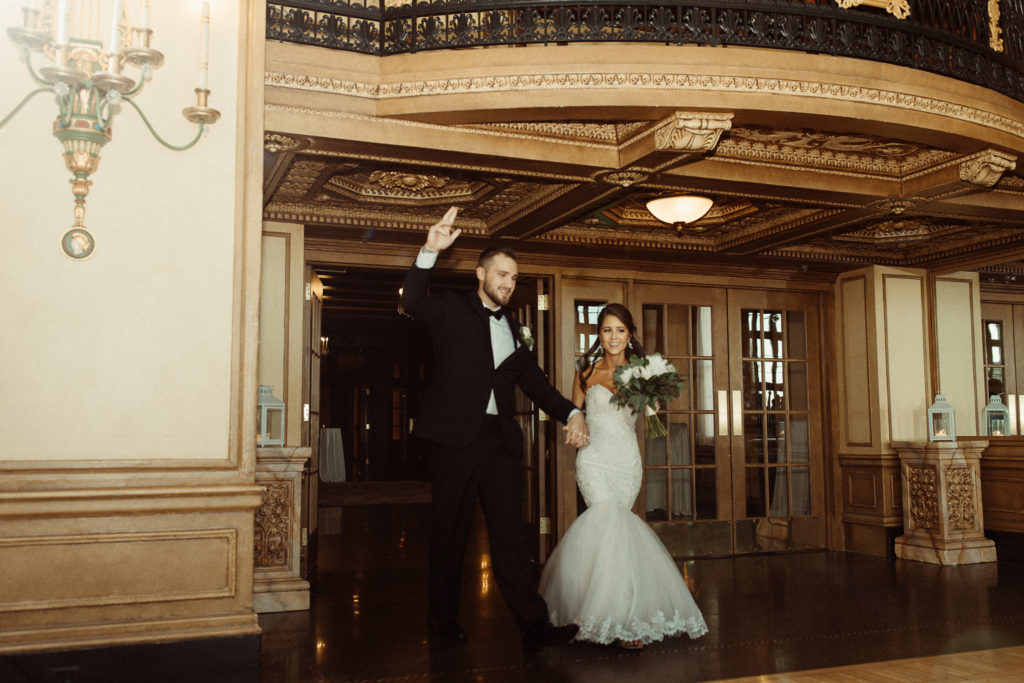 Bride and groom enter into the grand ballroom at Hotel Syracuse also known as Marriott Downtown, in Syracuse NY.