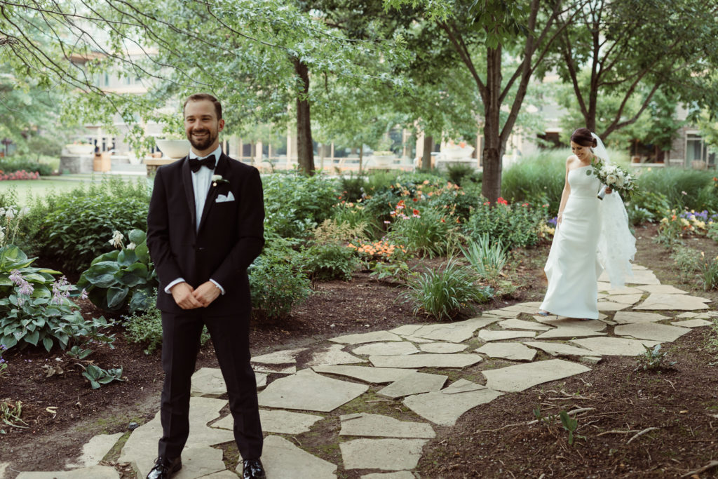 A couple's first look outside the Turningstone Resort, one of the best wedding venues in Syracuse.