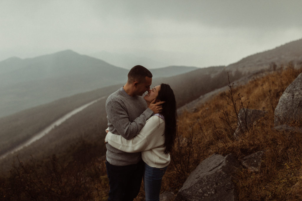 An example of what to wear for engagement photos can be neutral sweaters like this couple chose.
