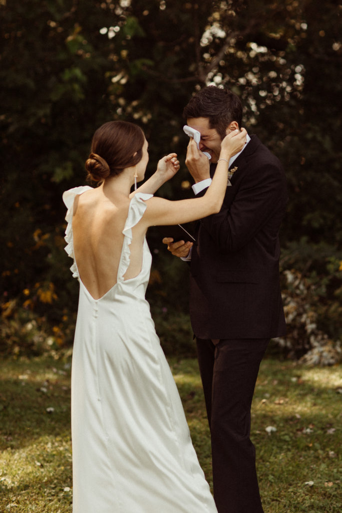 A groom cries during the reading of the couple's personal wedding vows. This provides for a unique wedding moment. Taken at Kester Homestead in Upstate NY.