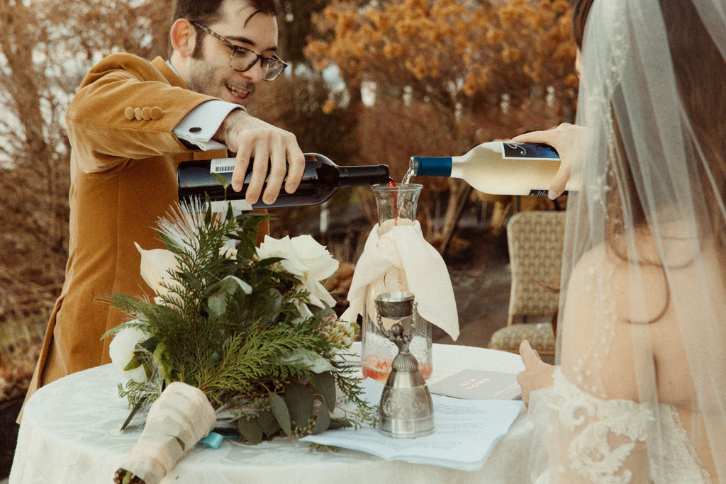 Couple performs unique unity ceremony with wine to represent the coming together of their lives.