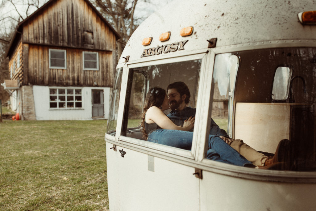 An engaged couple in their Airstream to show what is unique about their love story.
