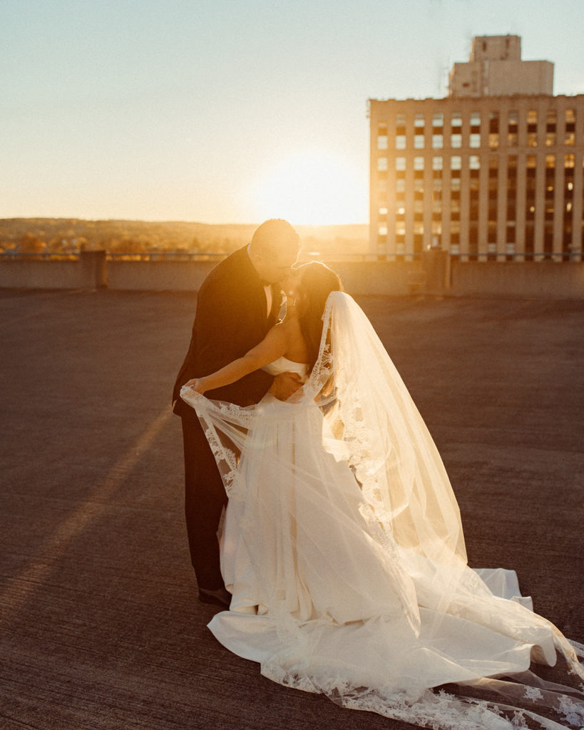 A rooftop kiss in downtown Syracuse, a popular wedding destination in Central New York.