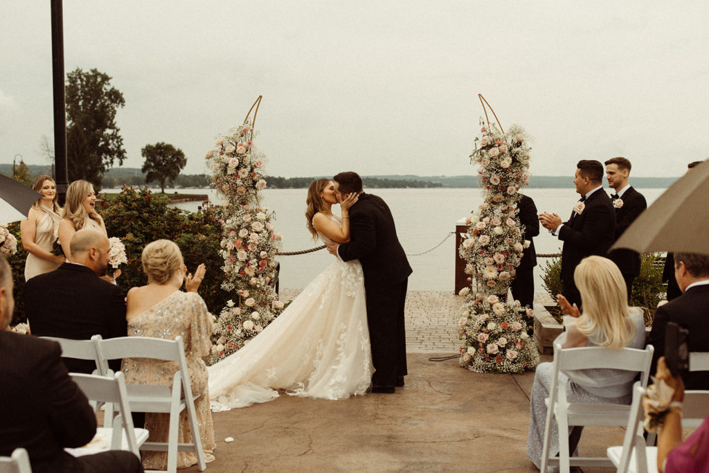 A couple shares their first kiss at a wedding venue outside of Buffalo, NY. A popular place for weddings in New York.